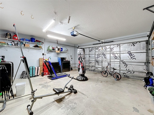 garage featuring concrete block wall and a garage door opener