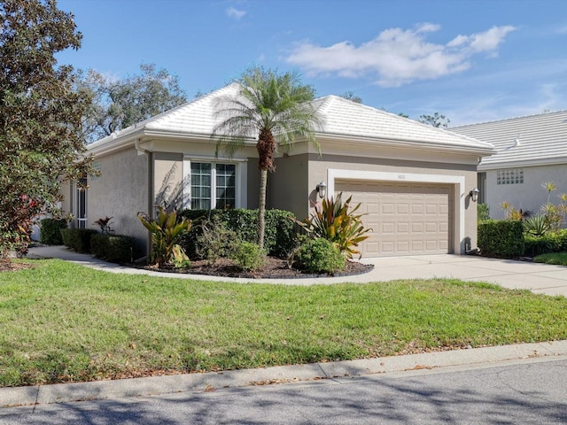 ranch-style home with an attached garage, a front lawn, concrete driveway, and stucco siding