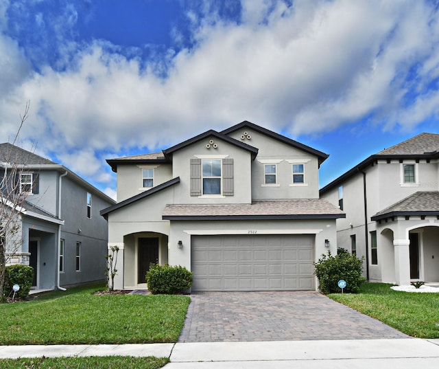 front facade with a front yard and a garage