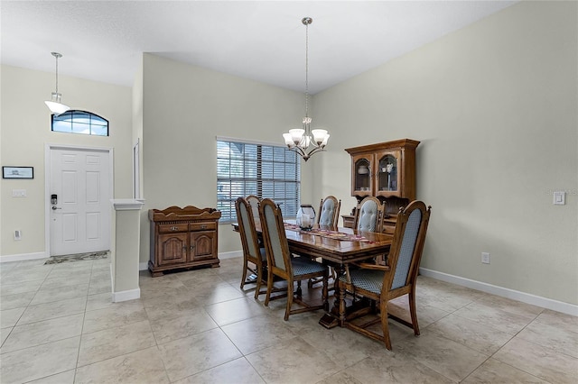 dining room with a healthy amount of sunlight, light tile patterned floors, baseboards, and a notable chandelier