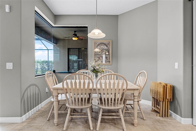 dining room with baseboards and a ceiling fan