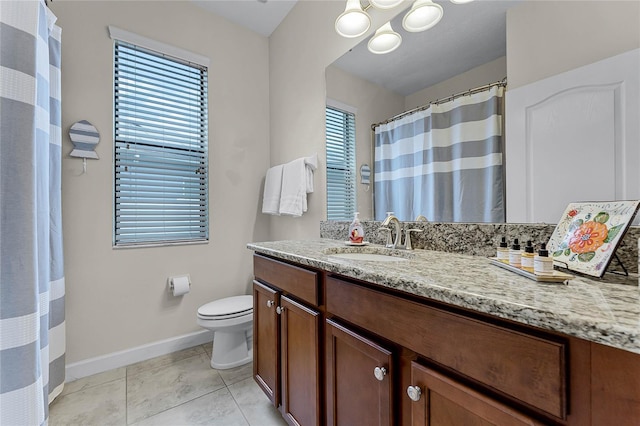 bathroom with toilet, tile patterned flooring, vanity, and baseboards