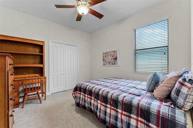 bedroom featuring a closet, a ceiling fan, and light colored carpet