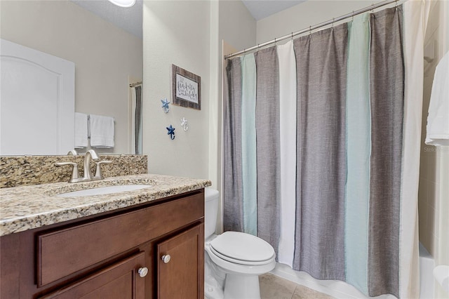 bathroom featuring tile patterned flooring, vanity, and toilet