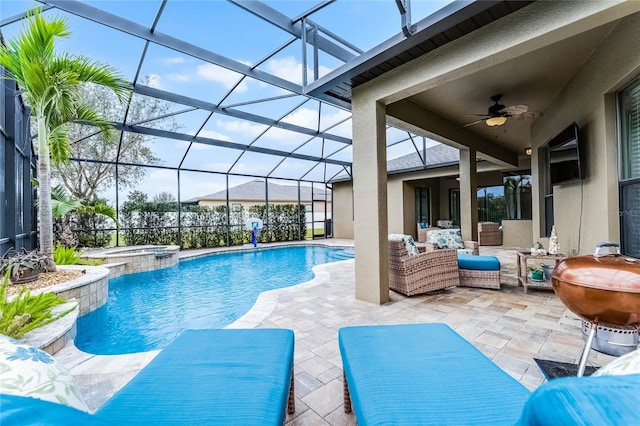 view of pool featuring a ceiling fan, glass enclosure, a patio, and an outdoor hangout area