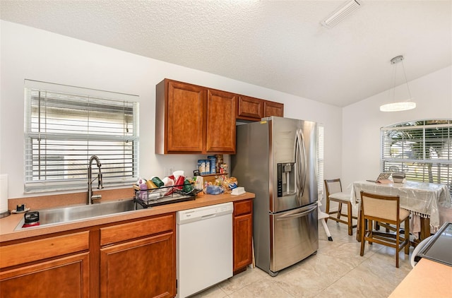 kitchen featuring visible vents, dishwasher, stainless steel fridge with ice dispenser, pendant lighting, and a sink