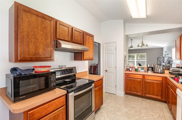 kitchen with black microwave, under cabinet range hood, electric range, vaulted ceiling, and light countertops