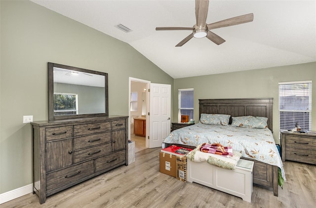 bedroom with visible vents, ensuite bathroom, vaulted ceiling, light wood-type flooring, and baseboards