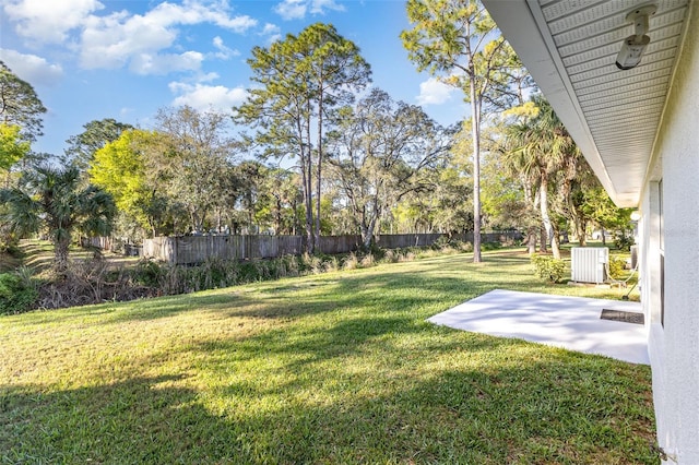 view of yard with fence and a patio