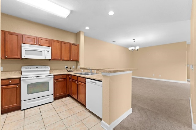 kitchen featuring kitchen peninsula, sink, white appliances, light carpet, and a chandelier