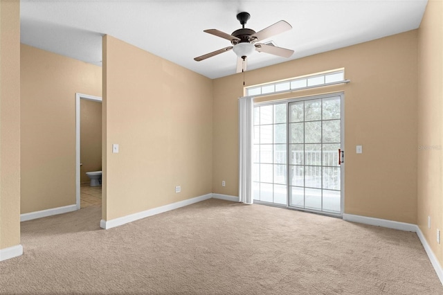 carpeted spare room with ceiling fan