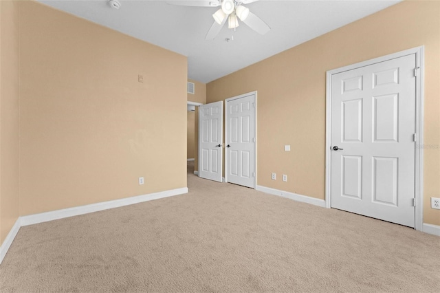 unfurnished bedroom with light carpet, a closet, and ceiling fan