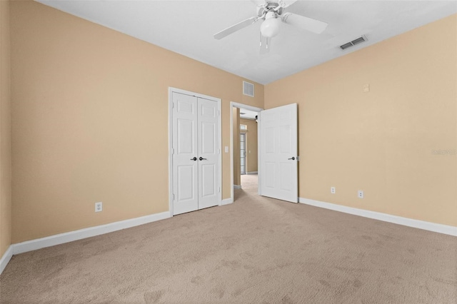 unfurnished bedroom with ceiling fan, carpet floors, and a closet