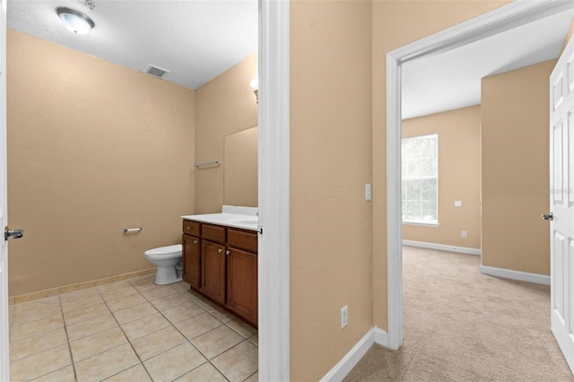 bathroom featuring tile patterned floors, toilet, and vanity