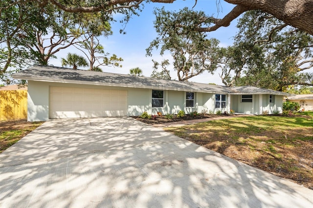 ranch-style home featuring a front lawn and a garage