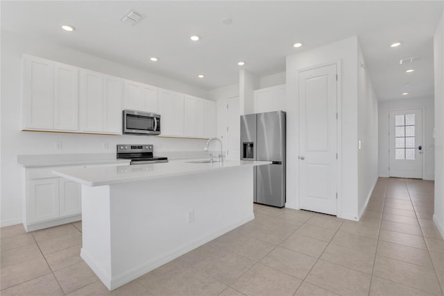 1620 Pelican Dr, Davenport, FL 33896 - kitchen with a center island with sink, sink, stainless steel appliances, and white cabinets