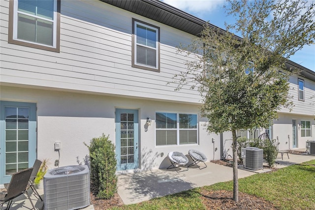 1620 Pelican Dr, Davenport, FL 33896 - rear view of property with central AC unit and a patio