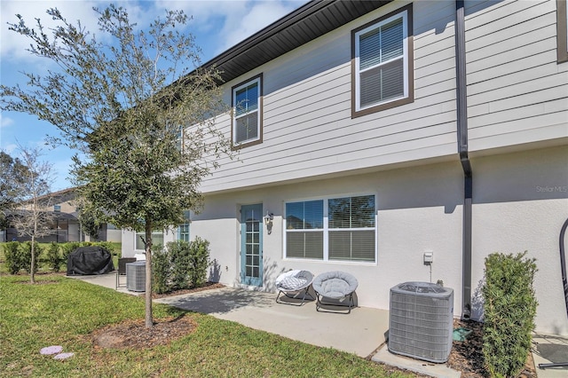 1620 Pelican Dr, Davenport, FL 33896 - rear view of property with cooling unit, a yard, and a patio
