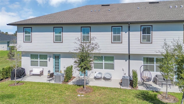 1620 Pelican Dr, Davenport, FL 33896 - back of house with a yard, a patio, and central AC