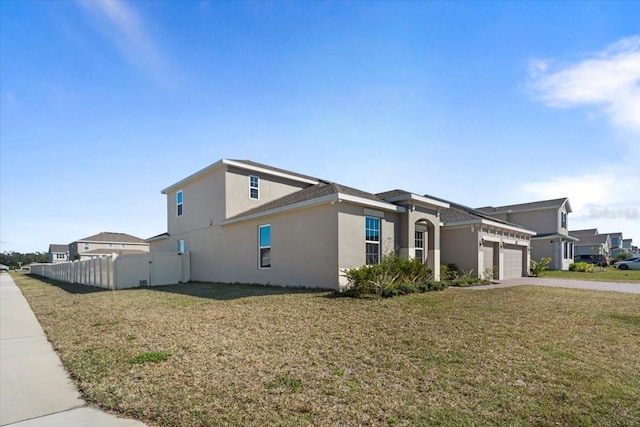 view of side of home with a garage, fence, concrete driveway, a lawn, and stucco siding