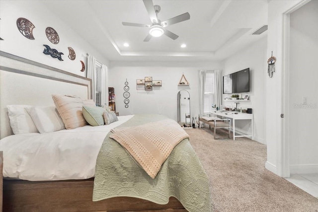 bedroom with recessed lighting, a raised ceiling, visible vents, light carpet, and ceiling fan