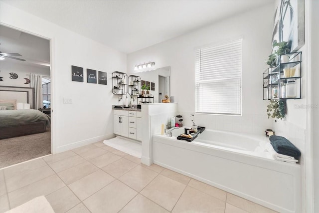 bathroom with ensuite bathroom, tile patterned flooring, vanity, and a bath