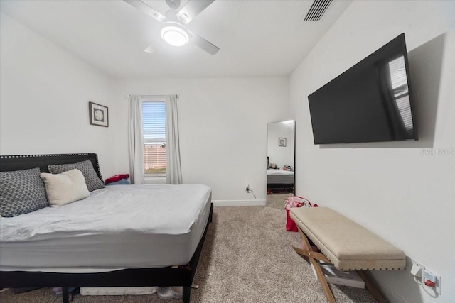 bedroom with baseboards, a ceiling fan, visible vents, and light colored carpet