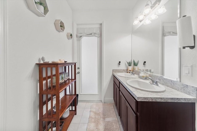 bathroom with double vanity, a sink, and tile patterned floors