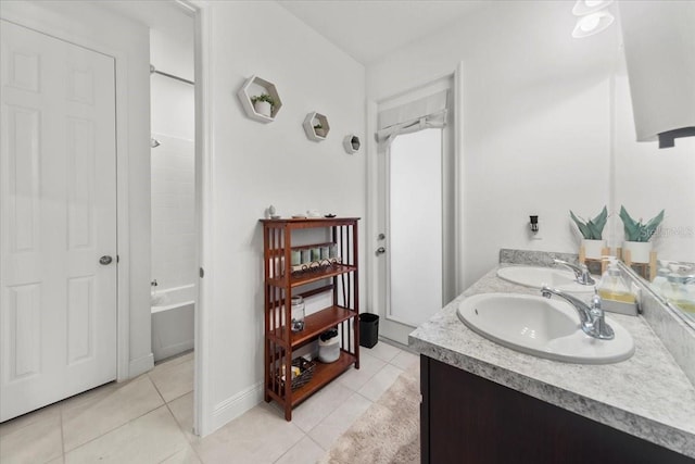 bathroom with double vanity, shower / bath combination, a sink, and tile patterned floors