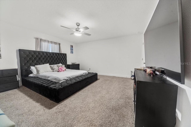 carpeted bedroom with ceiling fan and baseboards