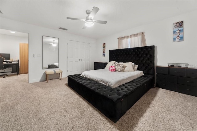 carpeted bedroom with a ceiling fan, a closet, visible vents, and baseboards