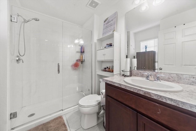 full bathroom featuring visible vents, toilet, a stall shower, vanity, and tile patterned floors