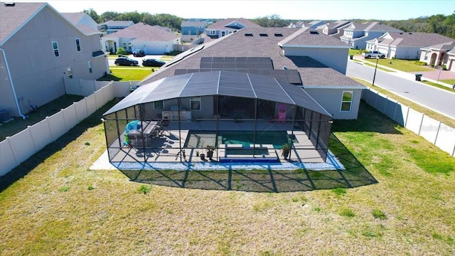 back of house featuring a fenced in pool, a residential view, a lanai, and a patio