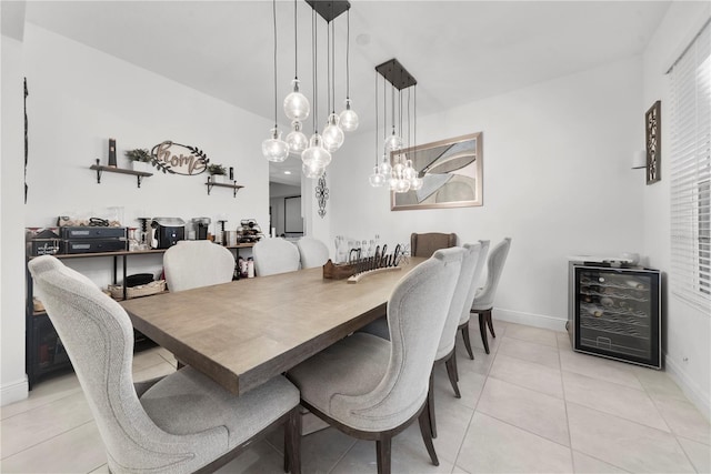 dining area with light tile patterned floors, beverage cooler, and baseboards