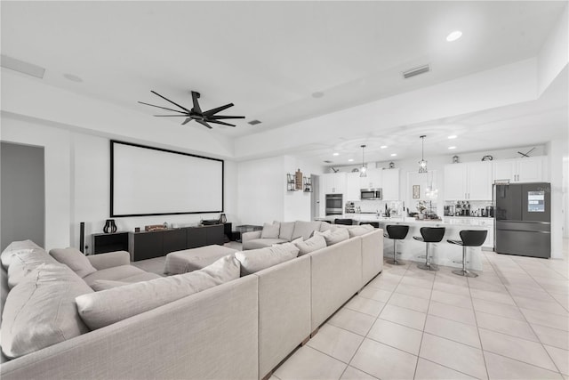 home theater room featuring light tile patterned floors, a ceiling fan, visible vents, and recessed lighting