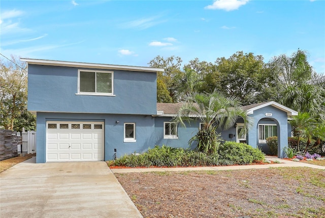 view of front of house featuring driveway, an attached garage, and stucco siding