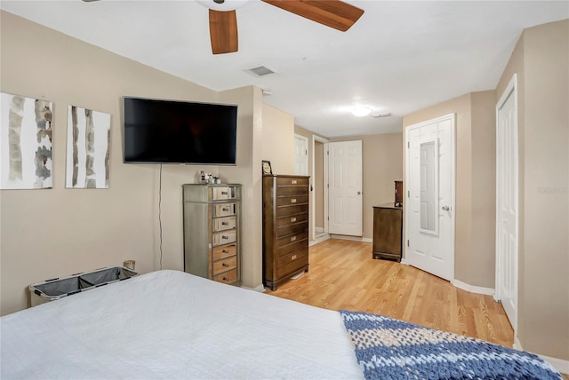 bedroom featuring visible vents, baseboards, light wood-style flooring, and a ceiling fan