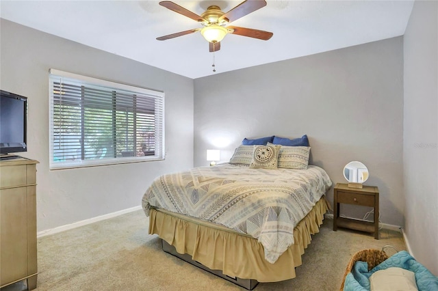 bedroom with light carpet, ceiling fan, and baseboards