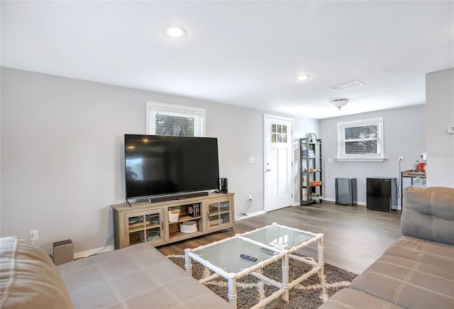 living area featuring recessed lighting, baseboards, and wood finished floors