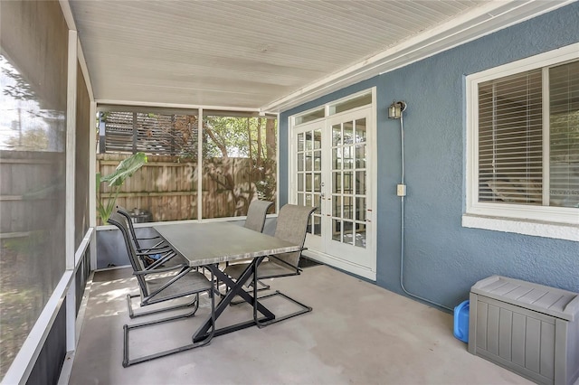 sunroom / solarium featuring french doors