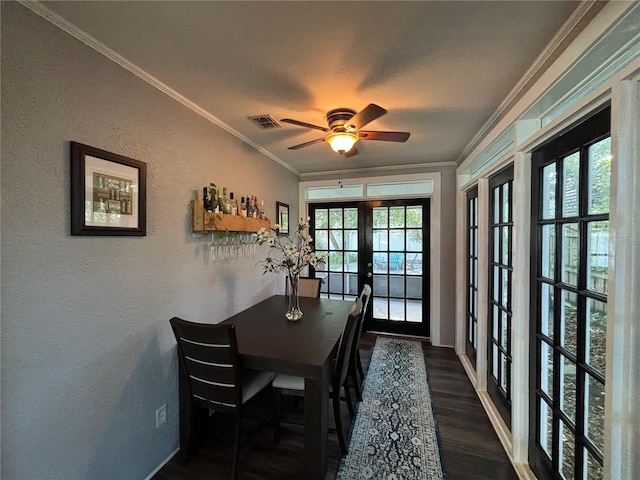 dining area with french doors, a textured wall, ornamental molding, wood finished floors, and a ceiling fan
