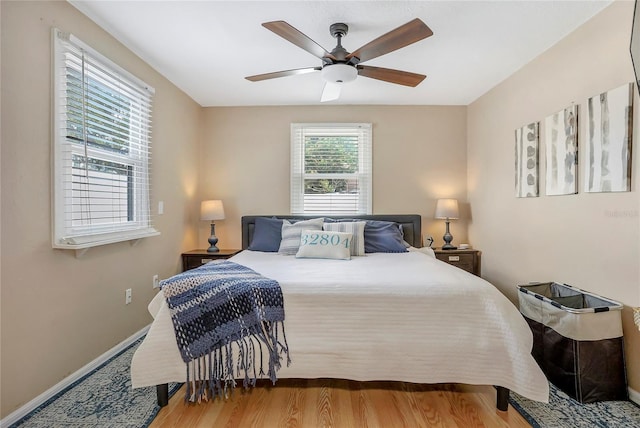 bedroom with wood finished floors, baseboards, and ceiling fan