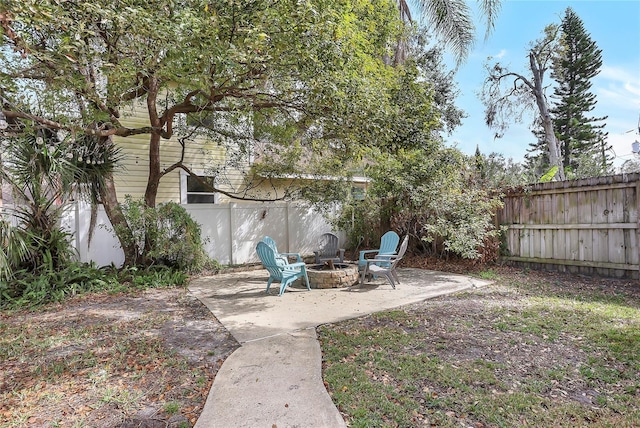 fenced backyard featuring a fire pit and a patio area