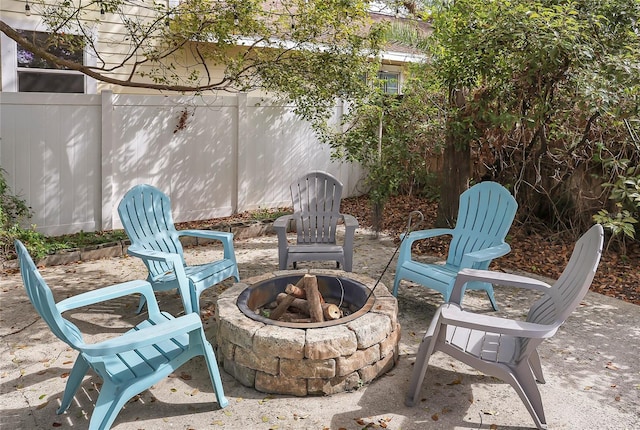 view of patio / terrace with an outdoor fire pit and fence