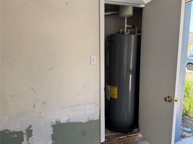 utility room with electric water heater