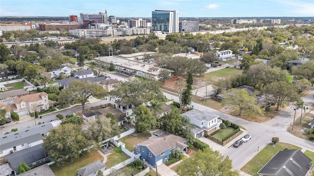 aerial view of property and surrounding area with nearby urban area
