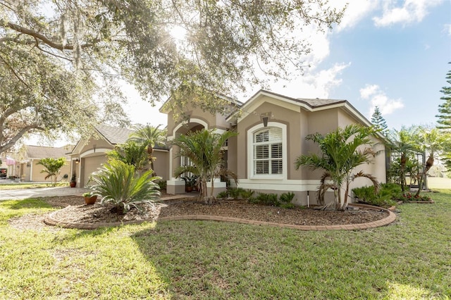 view of front facade featuring a front yard and a garage