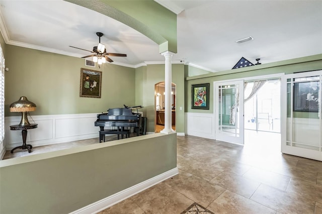 interior space with ornamental molding, ceiling fan, light tile patterned flooring, and ornate columns