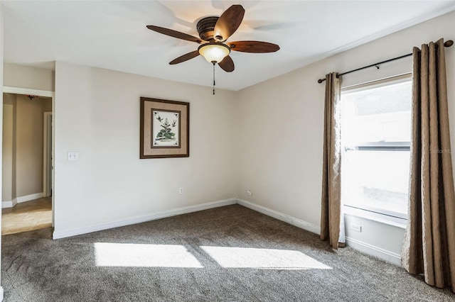 carpeted spare room with ceiling fan