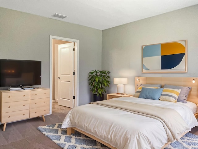 bedroom with dark colored carpet and visible vents